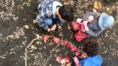 creativity-corner kids creating art on woodland floor