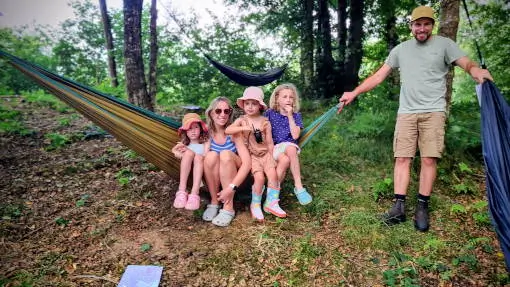 just-being adults and children sitting in hammocks